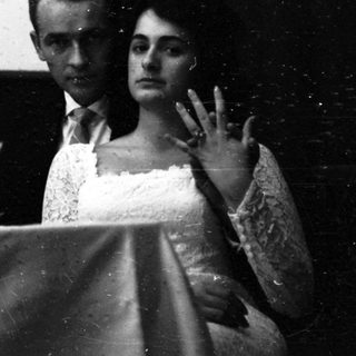 Couple watching film in darkened theater.
