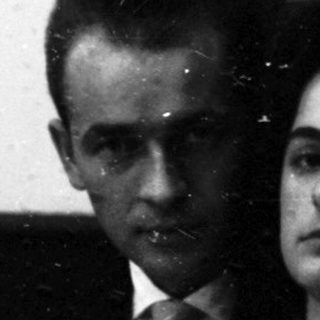 Couple watching film in darkened theater.