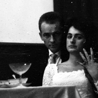 Couple watching film in darkened theater.