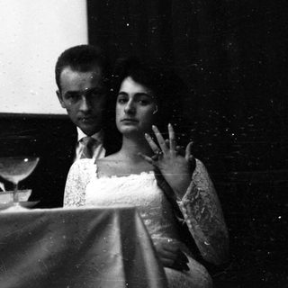 Couple watching film in darkened theater.