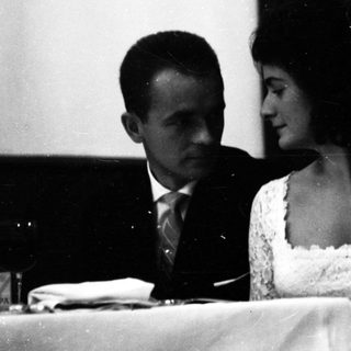 Couple seated together at a formal event.