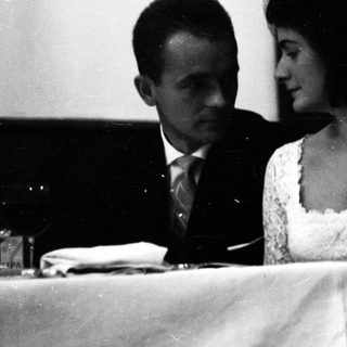 Couple seated together at a formal event.