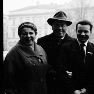 Five people posing together outdoors in mid-20th century clothing.