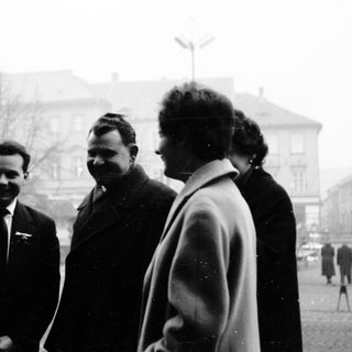 Five people posing together outdoors in mid-20th century clothing.