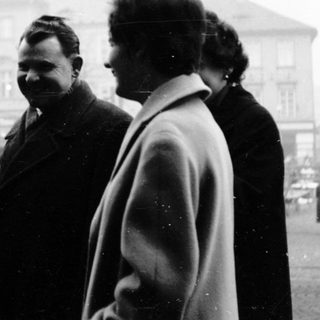 Five people posing together outdoors in mid-20th century clothing.