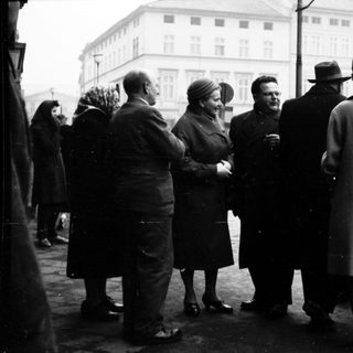 Group of people in formal attire gathered outdoors.