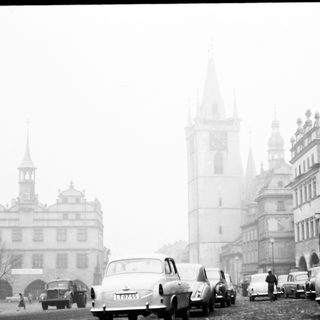 Mid-20th century European city street in fog.