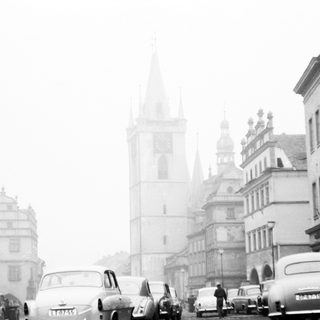 Mid-20th century European city street in fog.