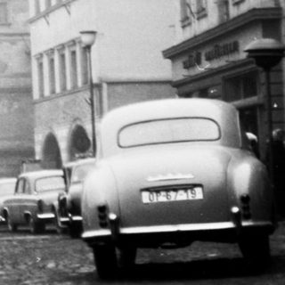 Mid-20th century European city street in fog.