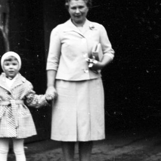 Family posing outside a train station.