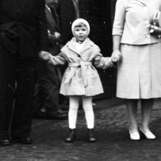 Family posing outside a train station.