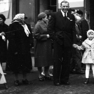 Family posing outside a train station.