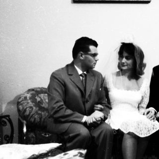 A wedding group portrait from the mid-20th century.