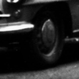 Vintage street scene with parked vintage cars.
