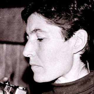 Person holding vintage camera indoors.