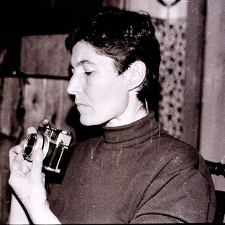Person holding vintage camera indoors.