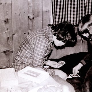 Two people playing cards indoors together.