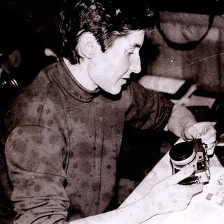 Person soldering electronic components on a circuit board.