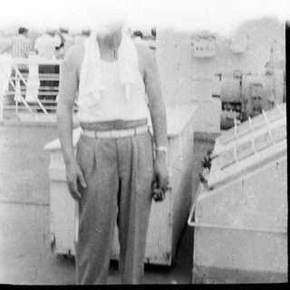 Person standing on dock near ship.