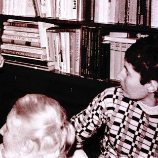 Magician performing trick with handkerchief in library setting.