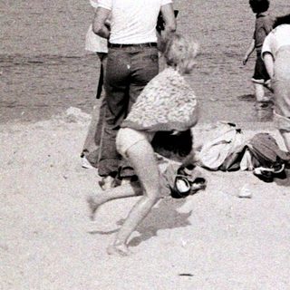 People playing and relaxing on a beach.