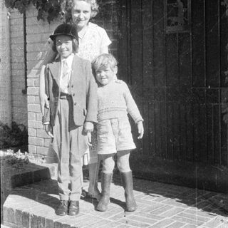 Family portrait from mid-20th century outdoors.