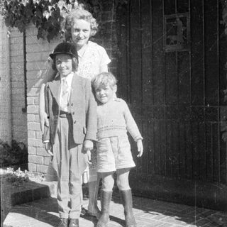Family portrait from mid-20th century outdoors.