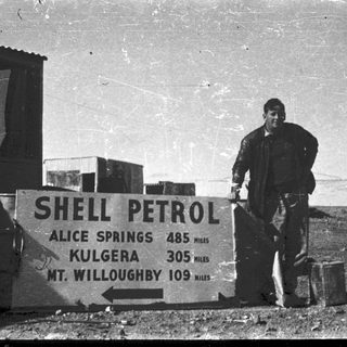 Shell petrol station sign with distances to nearby towns.