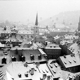 Historic European city covered in snow.