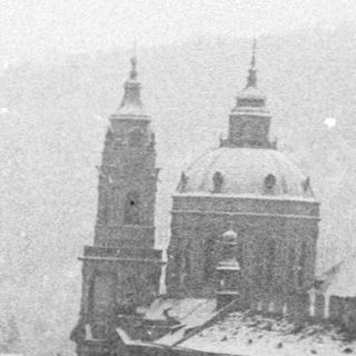 Historic European city covered in snow.
