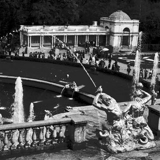 Elegant historic garden fountain with classical sculptures.