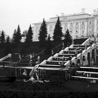 Historic palace with cascading fountains and grand staircases.