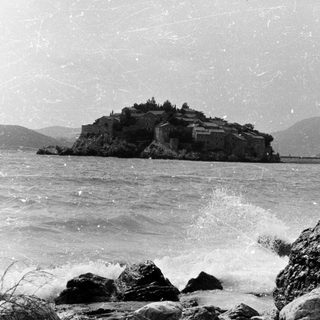 Island fortress surrounded by crashing waves.