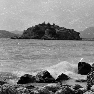 Isolated coastal fortress on rocky island.