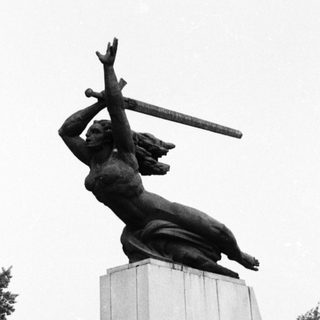 Soviet war memorial statue with sword.