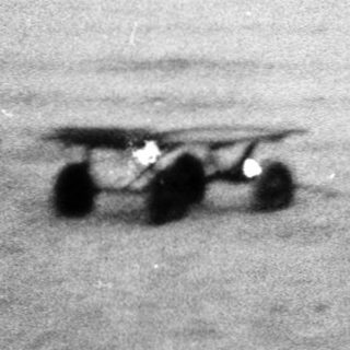 Small boats on calm sea near shore.