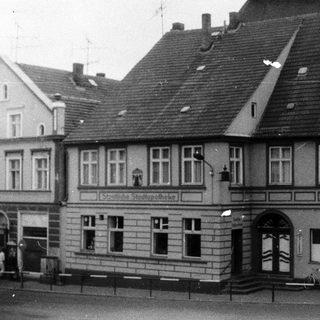 Historical black-and-white photo of a municipal pharmacy building.