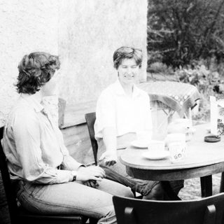 Four people enjoying a meal outdoors together.