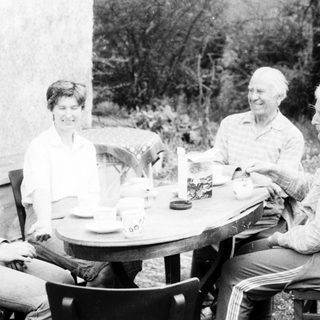 Four people enjoying a meal outdoors together.