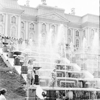 Historic fountain with water cascades and statues.