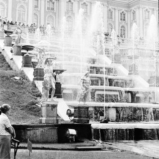 Historic fountain with water cascades and statues.