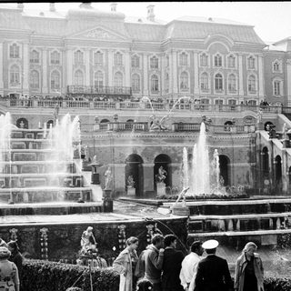 Grand palace gardens with elaborate fountains and classical architecture.