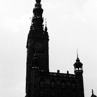 Tall Gothic-style church tower with clock.