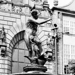 Baroque fountain with mythological figures and ornate basin.