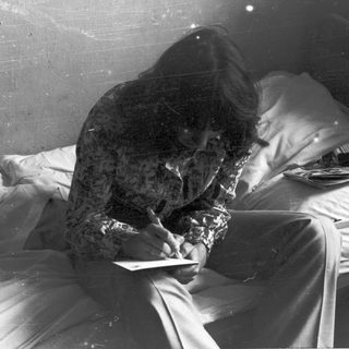 Person sleeping on covered hospital bed.