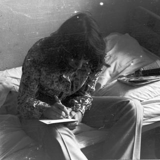 Person sleeping on covered hospital bed.