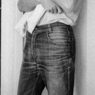 A man holding a smiling baby indoors.