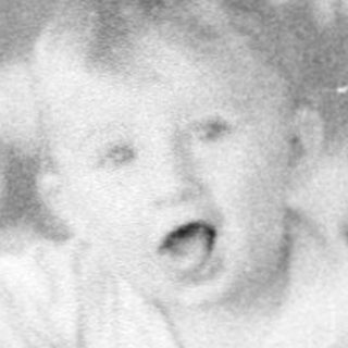 Baby crying in a crib.