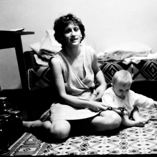 Woman and toddler playing indoors together.