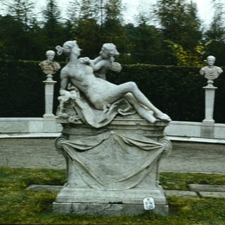 Baroque-style marble fountain sculpture with reclining figures.